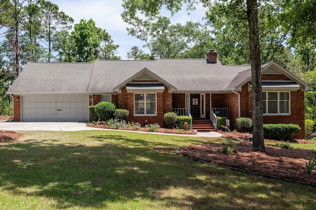 914 Deercrest Cir, Evans, GA 30809 - view of front of house with brick siding, covered porch, a garage, driveway, and a chimney