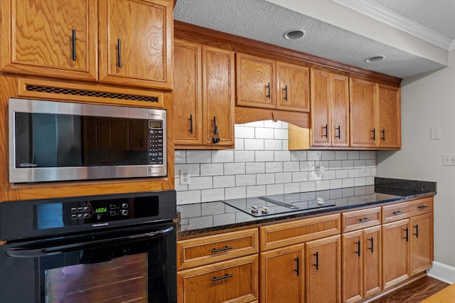 914 Deercrest Cir, Evans, GA 30809 - kitchen with black appliances, decorative backsplash, ornamental molding, dark stone counters, and brown cabinets