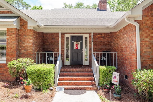 914 Deercrest Cir, Evans, GA 30809 - view of exterior entry featuring brick siding, a chimney, a porch, and a shingled roof