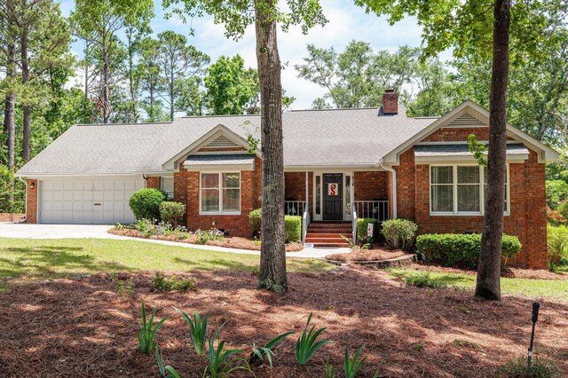 914 Deercrest Cir, Evans, GA 30809 - view of front of property featuring brick siding, a chimney, a garage, and covered porch