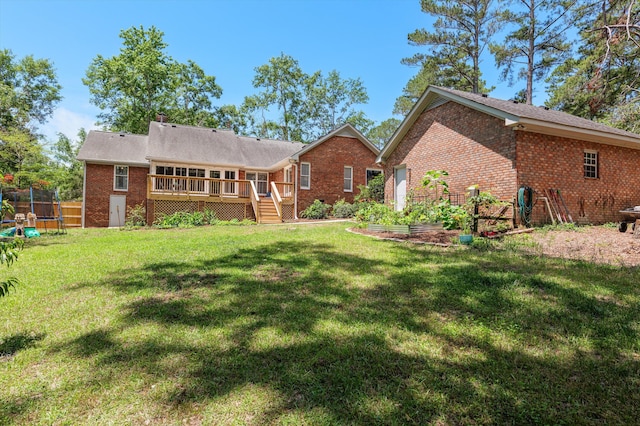 914 Deercrest Cir, Evans, GA 30809 - back of property with a trampoline, brick siding, a deck, and a lawn