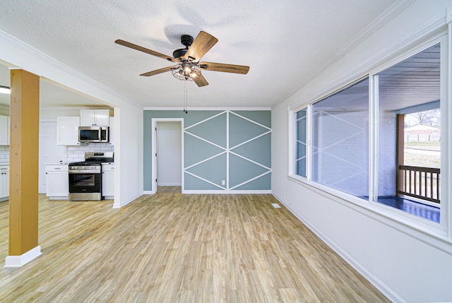 unfurnished living room featuring ceiling fan, a textured ceiling, crown molding, and light wood-type flooring