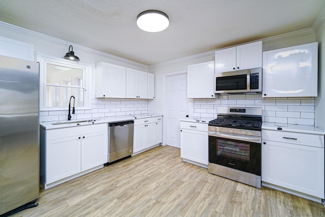 kitchen featuring sink, white cabinets, and stainless steel appliances