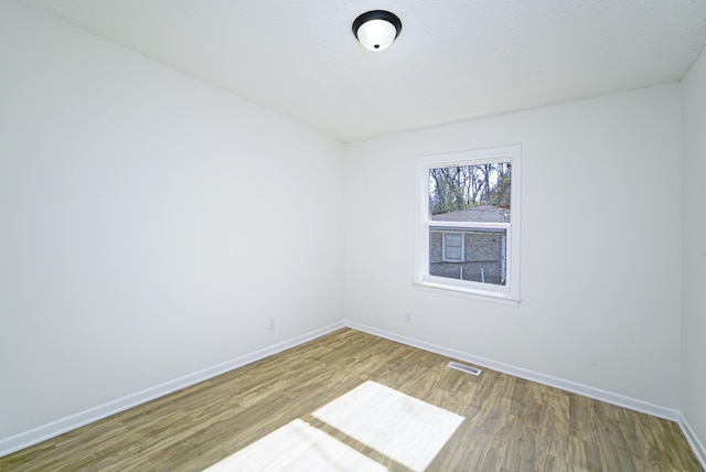 spare room with hardwood / wood-style flooring