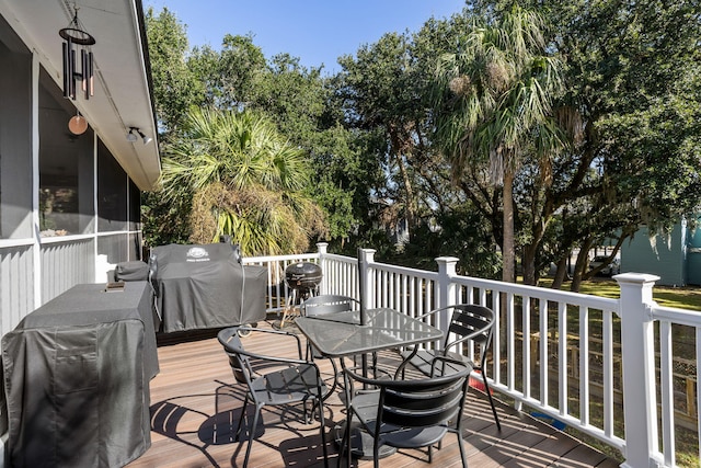 deck with a water view and a grill