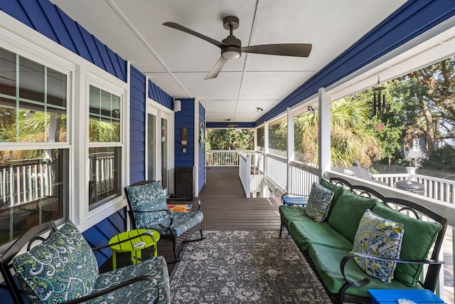 sunroom / solarium featuring ceiling fan