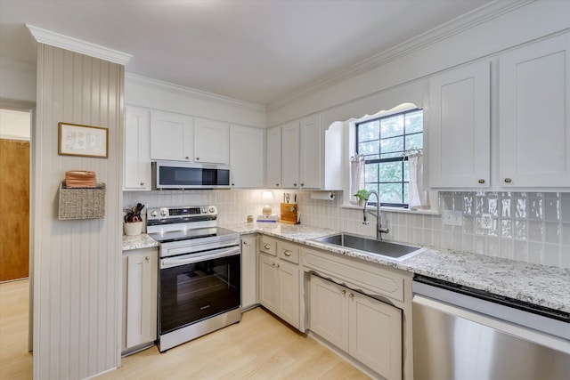 3866 Villa Ln, Martinez, GA 30907 - kitchen featuring stainless steel appliances, ornamental molding, light wood finished floors, decorative backsplash, and light stone counters