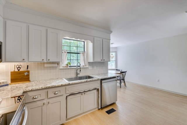 3866 Villa Ln, Martinez, GA 30907 - kitchen featuring dishwasher, decorative backsplash, light wood-type flooring, light stone countertops, and crown molding