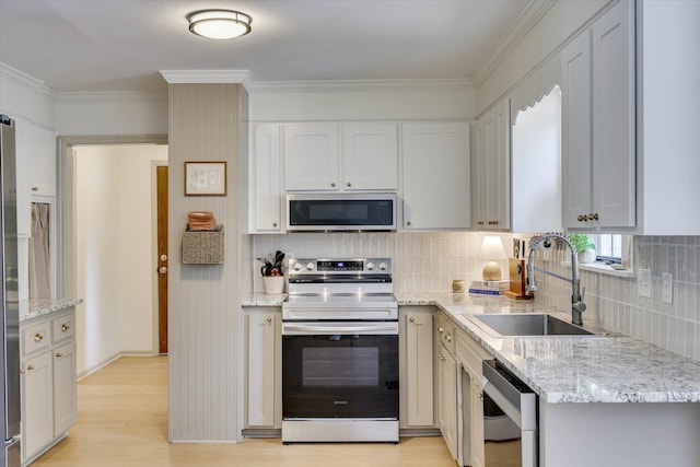 3866 Villa Ln, Martinez, GA 30907 - kitchen featuring stainless steel appliances, light wood-type flooring, light stone counters, ornamental molding, and tasteful backsplash