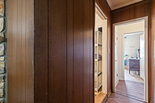 hallway featuring ornamental molding and wood-type flooring