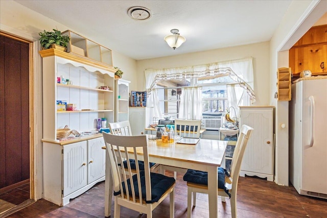 dining area with cooling unit and dark hardwood / wood-style floors