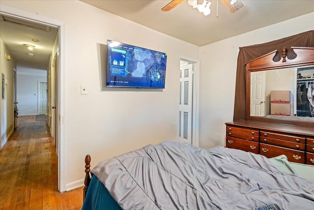 bedroom with hardwood / wood-style floors and ceiling fan