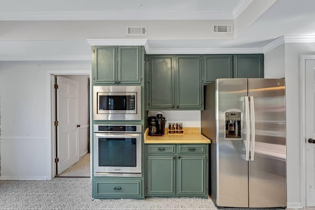 2928 Foxhall Cir, Augusta, GA 30907 - kitchen with green cabinetry, appliances with stainless steel finishes, light countertops, and ornamental molding