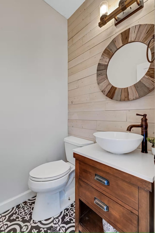 2928 Foxhall Cir, Augusta, GA 30907 - bathroom featuring wood walls, vanity, toilet, tile patterned floors, and baseboards