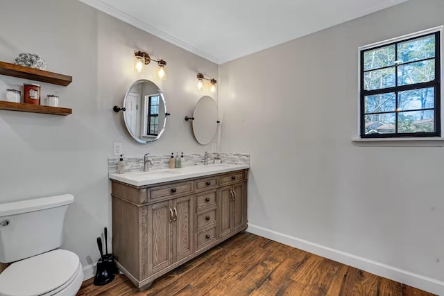 2928 Foxhall Cir, Augusta, GA 30907 - bathroom featuring baseboards, wood finished floors, toilet, double vanity, and crown molding