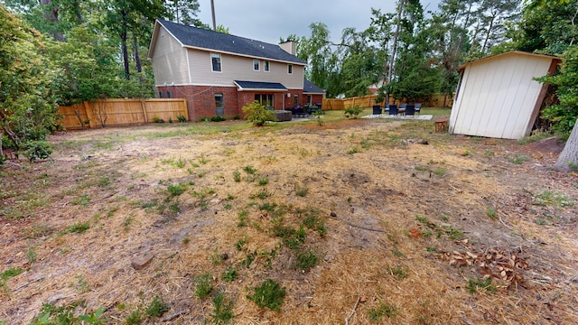 2928 Foxhall Cir, Augusta, GA 30907 - view of yard with a patio area, a storage unit, an outbuilding, and fence