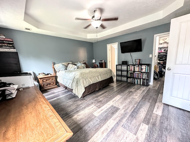 903 Arbor Springs Cir, Grovetown, GA 30813 - bedroom featuring a raised ceiling, wood finished floors, a spacious closet, and ceiling fan