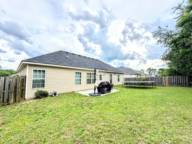 903 Arbor Springs Cir, Grovetown, GA 30813 - back of property with a fenced backyard, a trampoline, and a patio area
