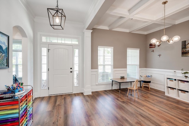entryway with beamed ceiling, a chandelier, coffered ceiling, a wainscoted wall, and wood finished floors