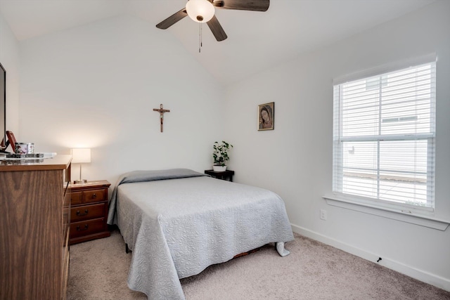 bedroom featuring lofted ceiling, baseboards, multiple windows, and carpet flooring