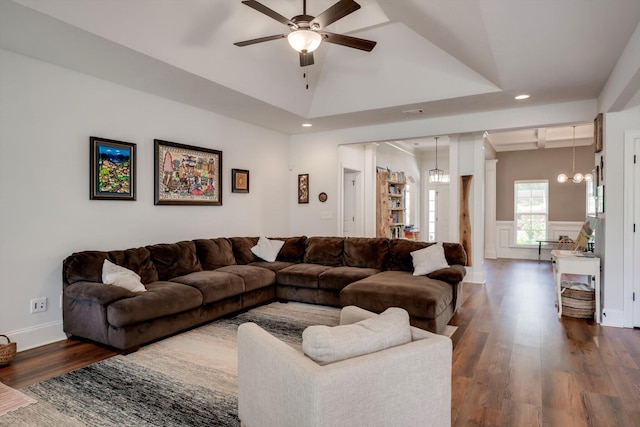 living room with wainscoting, recessed lighting, dark wood finished floors, and ceiling fan with notable chandelier