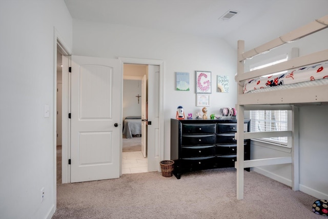 bedroom featuring lofted ceiling, visible vents, carpet, and baseboards