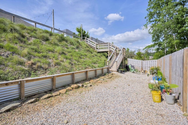 view of yard with stairs and a fenced backyard