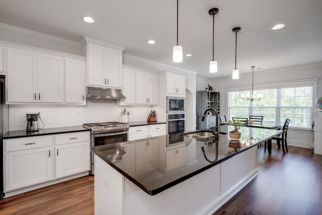 kitchen with crown molding, dark wood-style flooring, appliances with stainless steel finishes, and under cabinet range hood