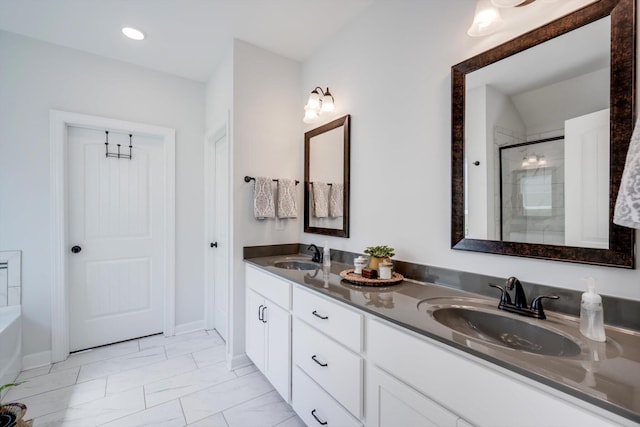 full bathroom featuring double vanity, a shower stall, marble finish floor, and a sink
