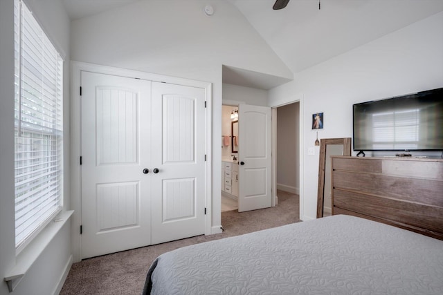 bedroom featuring a closet, carpet flooring, lofted ceiling, and baseboards