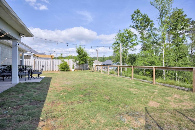 view of yard with a fenced backyard and a patio area