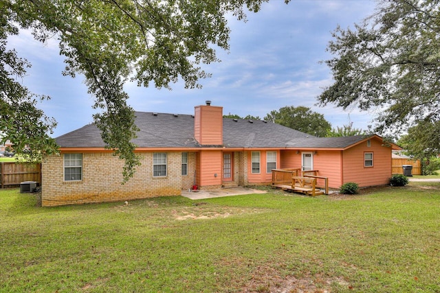 rear view of house with a deck, central AC unit, a patio area, and a lawn