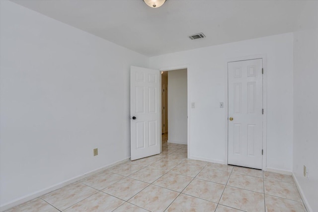 spare room with light tile patterned floors