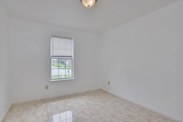 empty room with light tile patterned floors