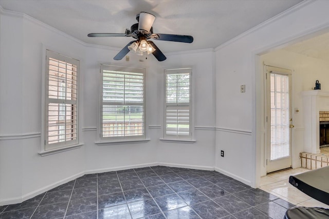 interior space with ceiling fan and crown molding