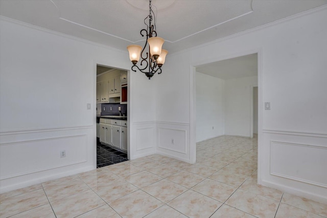 unfurnished dining area with light tile patterned flooring, ornamental molding, and a notable chandelier