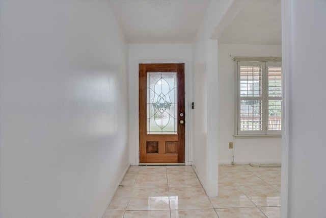 foyer entrance with light tile patterned floors