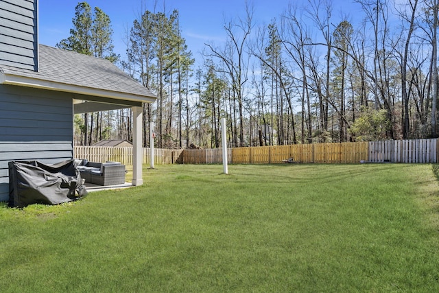 view of yard with outdoor lounge area and a fenced backyard