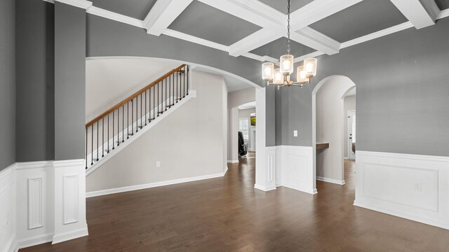 interior space featuring arched walkways, a notable chandelier, beamed ceiling, and wood finished floors