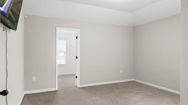 carpeted empty room with baseboards