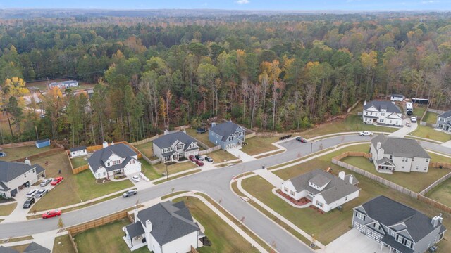 bird's eye view featuring a forest view and a residential view