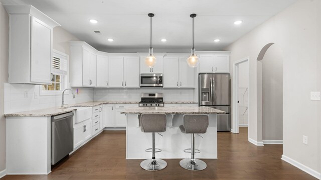 kitchen featuring white cabinetry, appliances with stainless steel finishes, and a center island