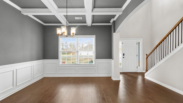 interior space featuring a chandelier, beam ceiling, crown molding, and coffered ceiling