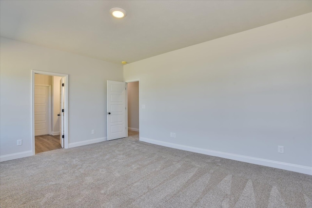 unfurnished room with light colored carpet