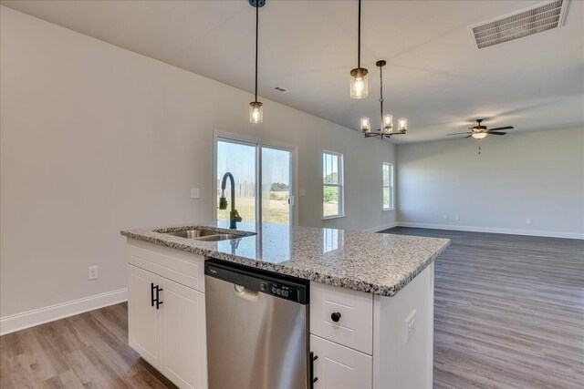 kitchen with dishwasher, light stone countertops, sink, and white cabinets