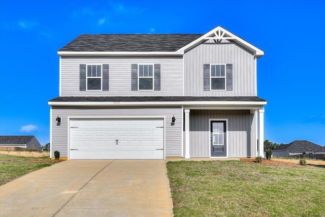 view of front of property featuring a garage and a front lawn