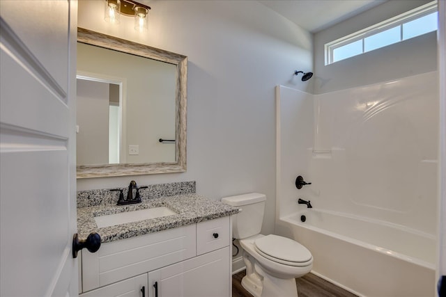 full bathroom with hardwood / wood-style flooring, vanity, toilet, and bathing tub / shower combination