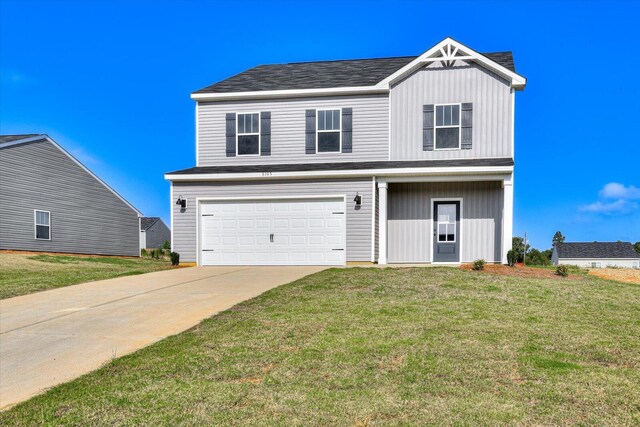 view of front of house with a garage and a front lawn