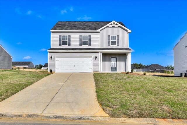 view of front facade with a garage and a front lawn