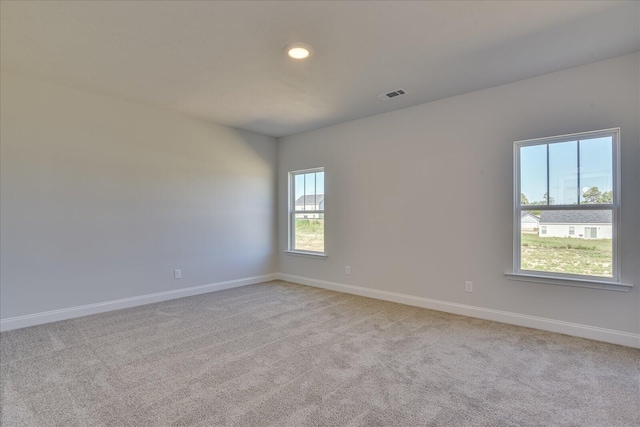 spare room with light carpet